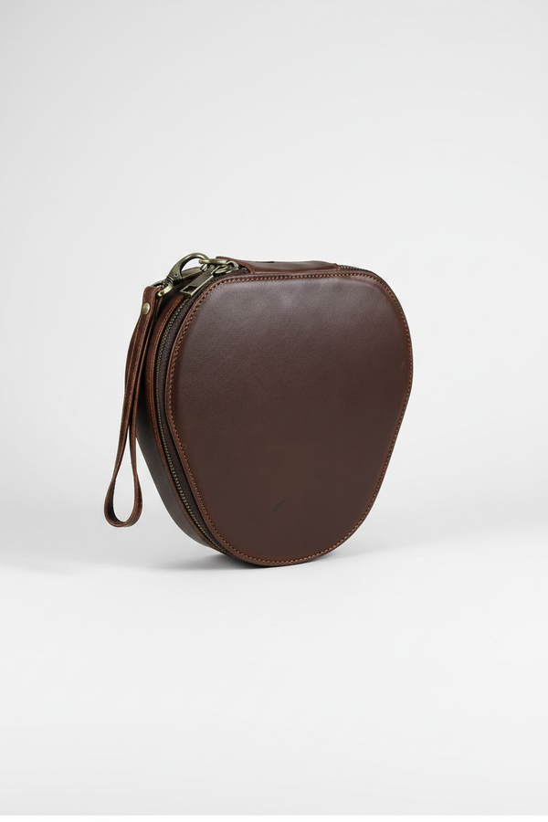 Dark brown full grain leather headphone case with a wrist strap and metal zip