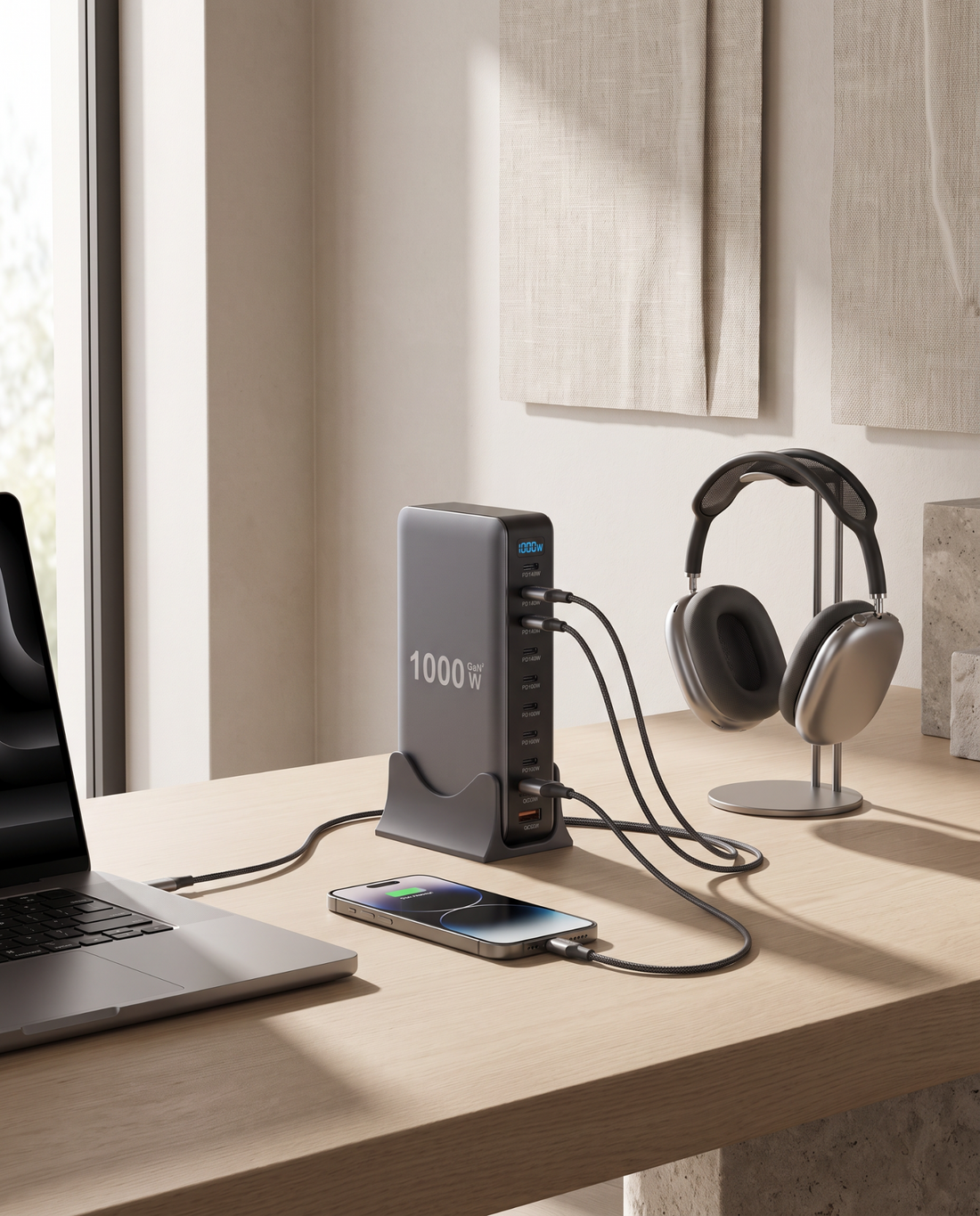 10-port GaN charging station powering a laptop, smartphone, and headphones on an oak desk
