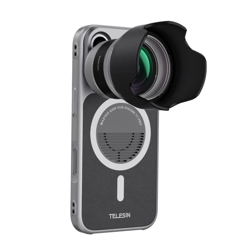 The magnetic lens adapter with hood, mounted to the silver phone case