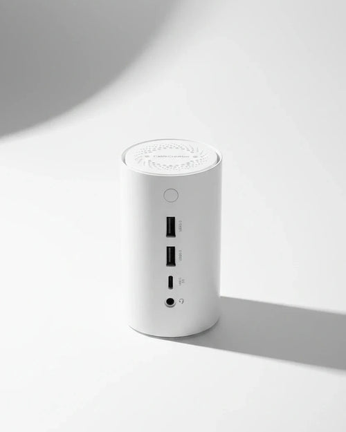 White cylindrical electronic device with ports on a white background