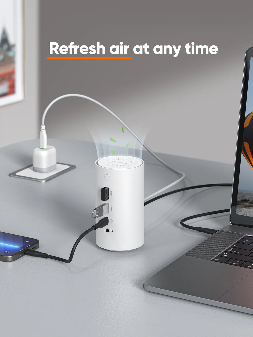 Small white air freshener on a desk with electronic devices, text 'Refresh air at any time'.