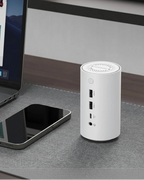 The docking station on a desk beside a laptop and phone, showing the ports serving both at once