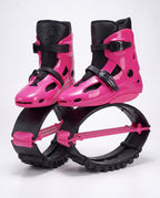 Hot pink and black kangaroo bounce jump shoes, spring loaded fitness boots, studio side view