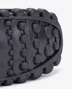 Close up of the knobbled rubber tread on the bounce jump shoe spring frame