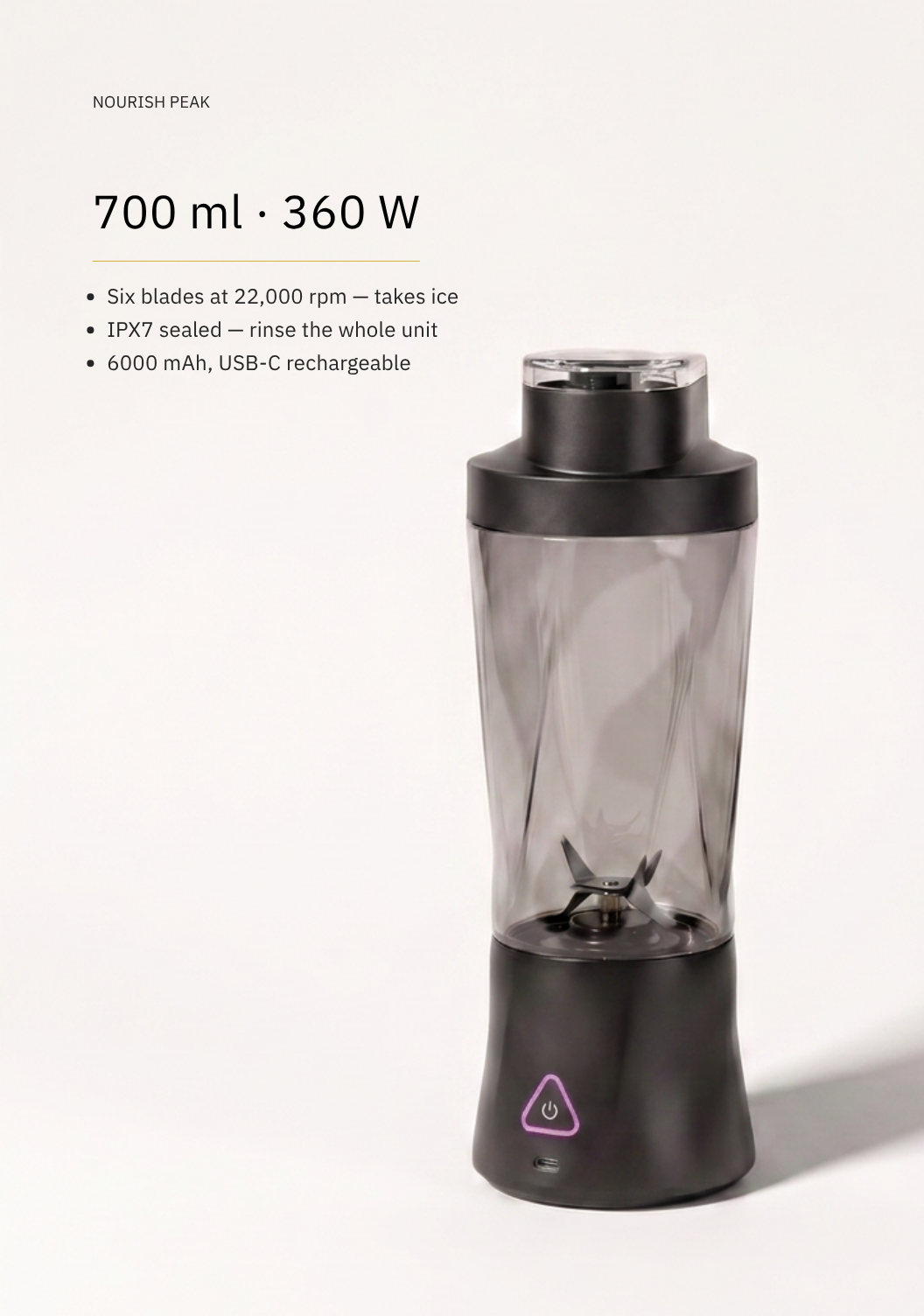 A Nourish Peak 700 ml 360 W portable blender shown on a clean off-white background with product specifications printed on the left. The blender has a dark gray translucent jar and matte black base and lid, with a small purple triangular logo on the base.