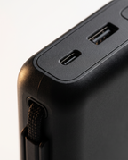 Close-up of USB-C and USB-A ports and built-in braided cable on the 26800mAh power bank
