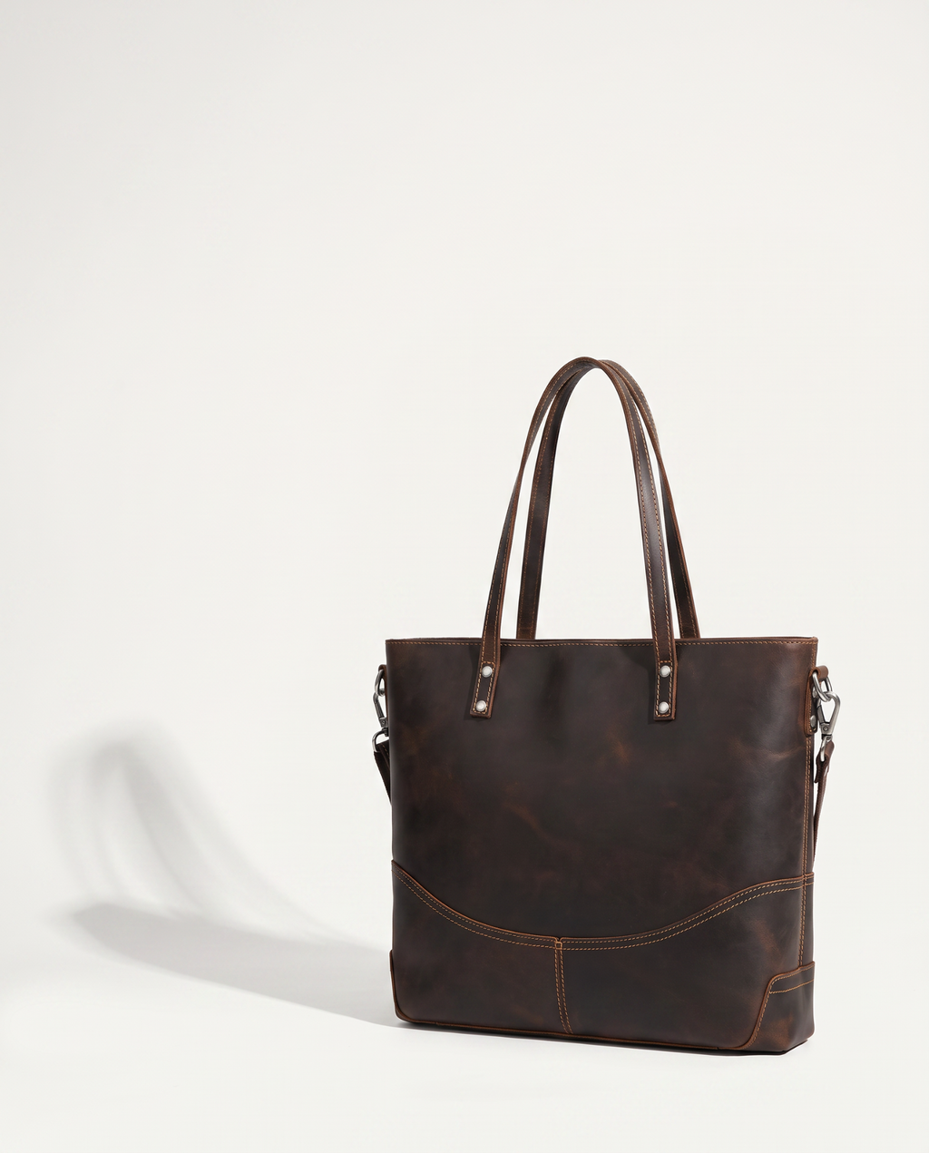 Dark brown crazy horse leather tote with double top handles and a detachable shoulder strap