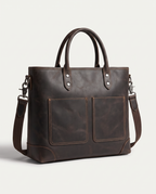 The tote seen from the front, showing dual handles, detachable strap and two utility pockets