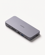 The 9-in-1 USB-C docking station in silver-grey, shown at an angle with its side port row visible
