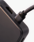 Close view of a braided USB-C cable plugged into the docking station's upstream port
