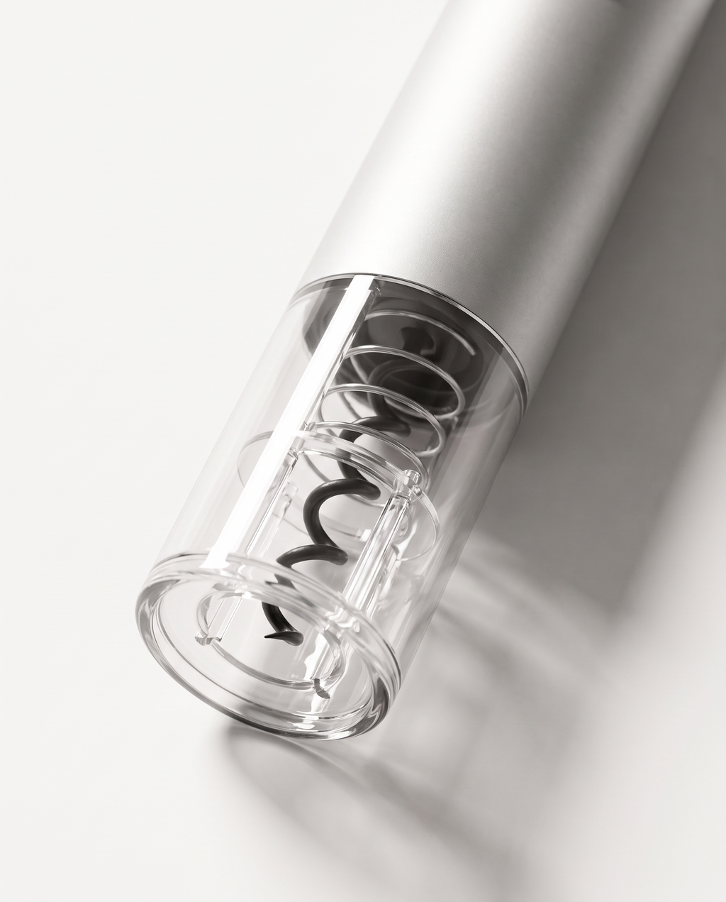 Macro detail of the clear bottle-neck receiver, showing the carbon steel spiral screw through the transparent lower section
