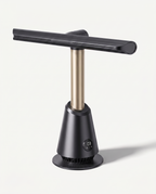 Matte black bladeless tower fan with telescopic column extended, shown three-quarter front on a soft white studio background