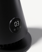 Macro detail of the tower fan's control panel and matte black ABS housing