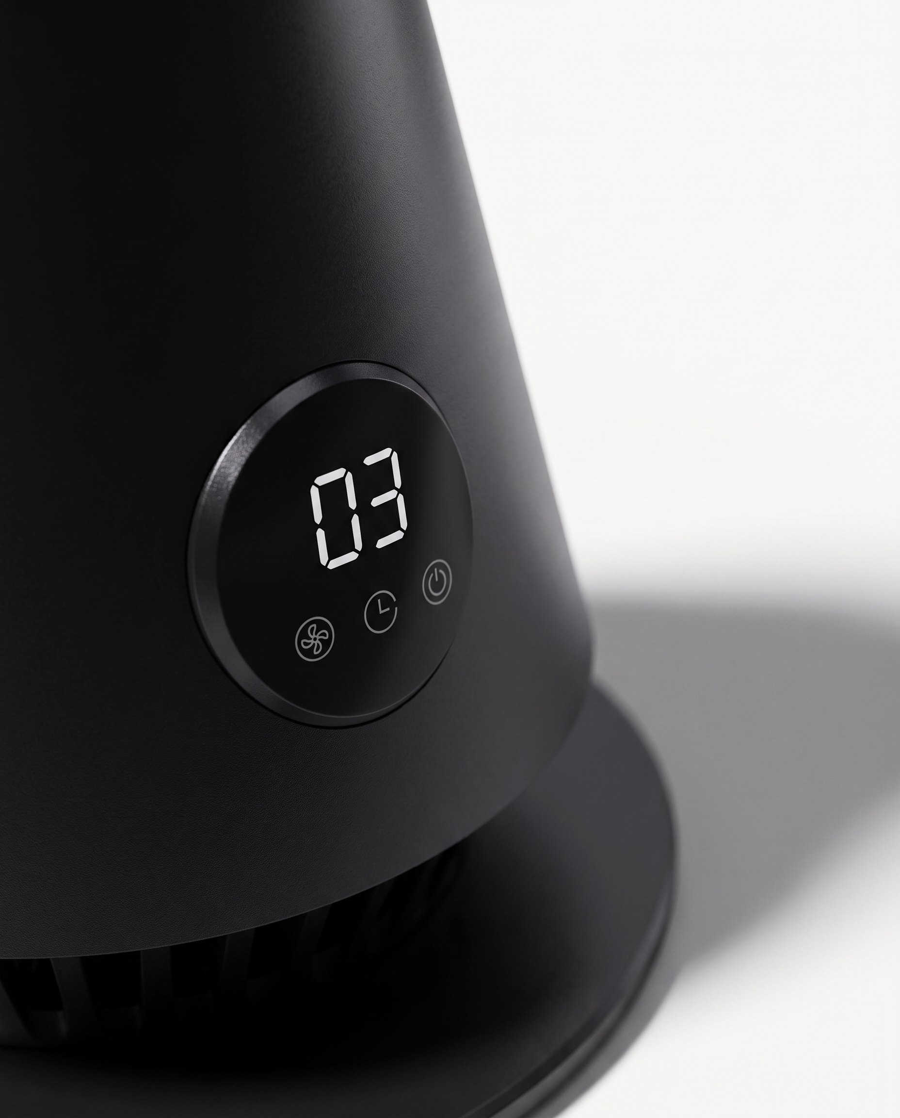 Macro detail of the tower fan's control panel and matte black ABS housing