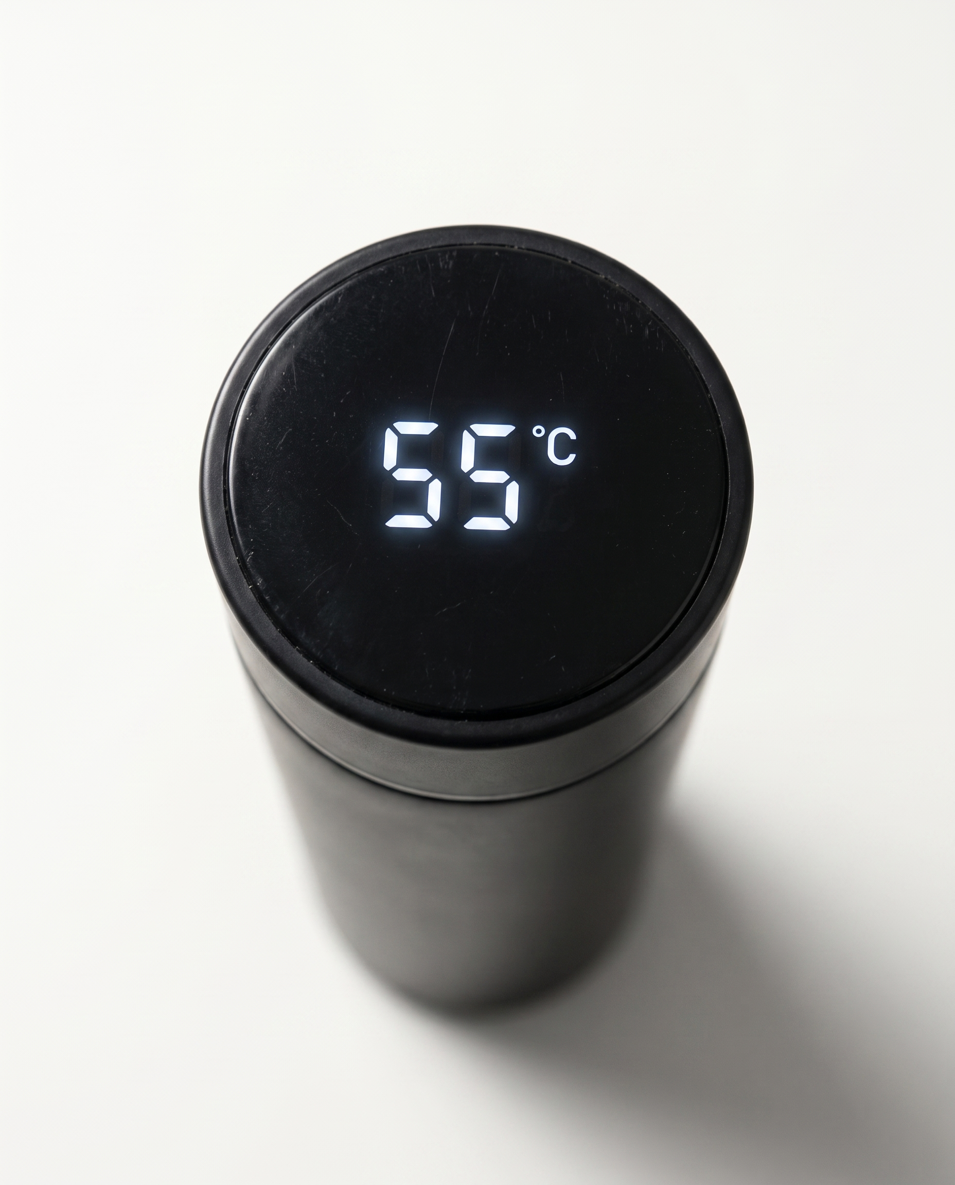 Macro detail of the lit temperature display set into the lid of the thermos cup