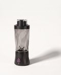 Portable blender in black with a clear tinted 700 ml bottle, six-blade assembly visible through the wall, on a soft white background