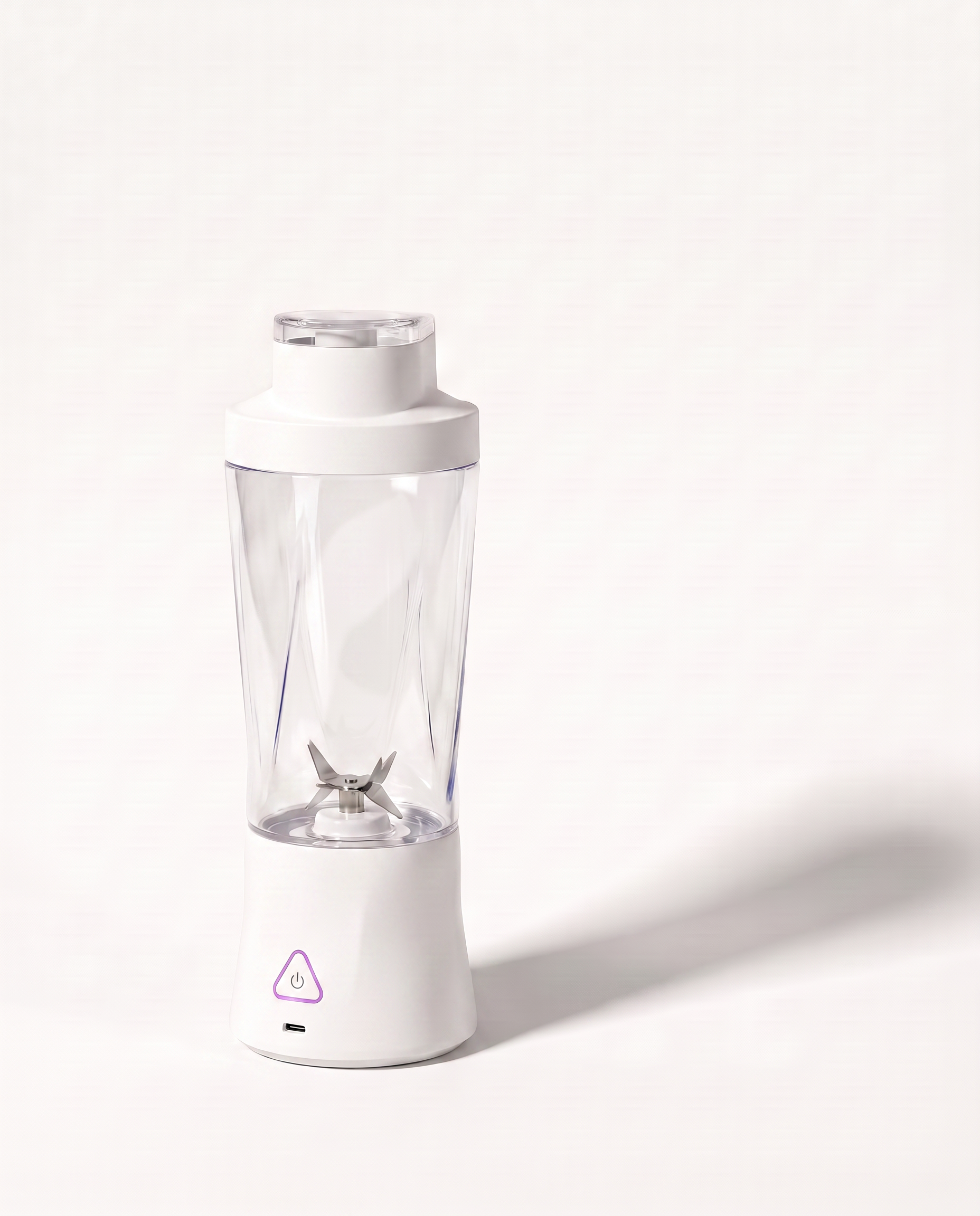 Portable blender in white with a clear 700 ml bottle, the six-blade assembly visible through the wall