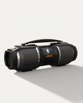 Bluetooth party speaker in matte black, horizontal cabinet with carry handle and lit Bluetooth display, on a soft white background