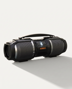 Bluetooth party speaker in matte black, horizontal cabinet with carry handle and lit Bluetooth display, on a soft white background