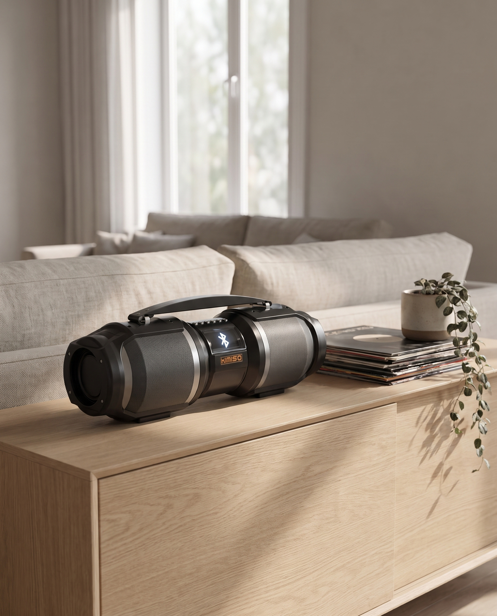 The Bluetooth speaker on an oak sideboard in a living room in afternoon light