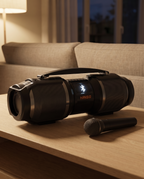 The Bluetooth speaker on a console table in the evening with a handheld microphone beside it, set up for karaoke