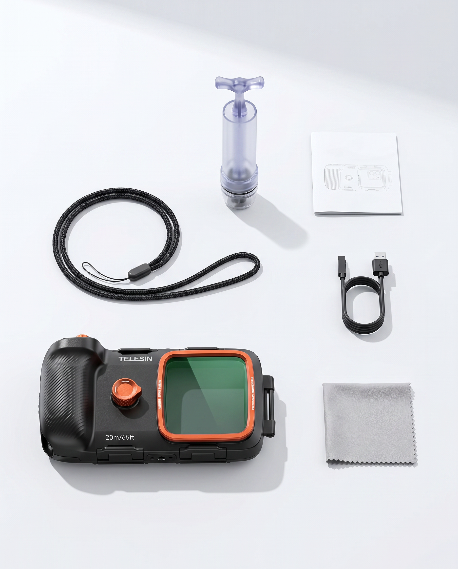 The full kit laid out: underwater housing, vacuum pump, safety hand strap, USB charging cable, cleaning cloth and instruction manual.