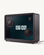 Floating lyrics speaker in idle mode showing a flip clock on its transparent screen