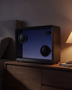 Transparent screen speaker glowing softly on a bedside table at night