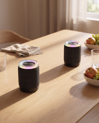 Two split speaker halves placed apart on an oak table as a stereo pair