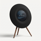 Floating Lyrics Grand in matte black on solid walnut legs, its circular display showing a line of song lyrics
