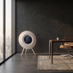 The off-white Floating Lyrics Grand in a corner office, seen from the side so the shallow tapered cabinet reads